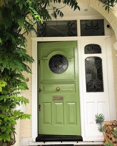 a green front door on a white house