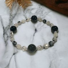 Create a striking piece of jewelry with our Rutilated Onyx Bracelet Kit. This kit features 10mm faceted black onyx and rutilated quartz beads, known for their captivating inclusions and unique character. Complementing these stunning stones are sterling silver seamless and corrugated round beads, adding a touch of elegance and sophistication to your bracelet. Each kit includes carefully selected components to ensure a harmonious blend of textures and finishes. Whether you're an experienced jewelr Black Natural Stones Bracelets For Jewelry Making, Black Natural Stone Bracelets For Jewelry Making, Black Agate Round Crystal Bracelet, Diy Jewelry For Beginners, Cute Beads, Bracelet Kit, Earring Kit, Jewelry Making Kits, Bracelet Kits