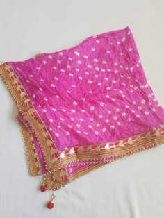 Ethnic Beautiful Bandhej Rajasthani silk Dupatta with heavy gotawork , latkans and pearls to be paired with ethnic Kurtas or white kurtas which gives a unique look which is a must buy.These dupattas have all four side pearl border for a attractive look. Dupatta length 2.25 metre Traditional Raw Silk Wear With Gota Work For Festivals, Festival Traditional Wear With Gota Work In Raw Silk, Bandhani Print Saree For Festival, Kundan Gota Work Traditional Drape Wear, Raw Silk Traditional Wear With Gota Work For Puja, Traditional Pink Gota Work Wear, Traditional Katan Silk Wear With Dori Work For Festivals, Raw Silk Dupatta With Gota Work For Puja, Festive Art Silk Traditional Wear With Gota Work