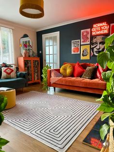 a living room filled with furniture and plants