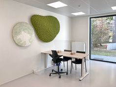 an empty office with two heart shaped sculptures on the wall