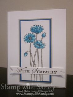 a card with blue flowers on it and a white ribbon around the edge that says, with sympathy