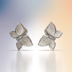 Experience Italian craftsmanship at its finest with our exquisite Diamond dangle drop earrings. The centerpiece of these earrings is a delicate butterfly with elegantly crafted leaves as its wings, creating a captivating and nature-inspired design. Available in both 14k and 18k gold, these earrings bring a touch of luxury and nature's beauty to your style. Elevate your look with the perfect blend of Italian artistry and organic elegance, shop now to adorn yourself with this unique masterpiece. 1