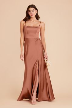 a bridesmaid in a long, satin dress with slits on the side