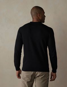 A versatile classic that's here to stay. Back by popular demand in a long sleeve version, this polo offers breathable comfort and superior softness with its Robles Yarn's 14gg Fine Knit composition. Crafted from 100% cotton soft sweater knit, it's your ultimate go-to for effortless style and comfort. Black Long Sleeve Henley For Fall, Black Long Sleeve Business Casual Sweater, Classic Polo Sweater With Ribbed Collar For Layering, Black Collared Polo Shirt For Winter, Classic Polo Sweater With Relaxed Fit, Black Polo Sweater With Ribbed Collar Crew Neck, Black Crew Neck Polo Sweater With Ribbed Cuffs, Black Crew Neck Polo Sweater For Work, Fitted Black Polo Sweater With Ribbed Cuffs