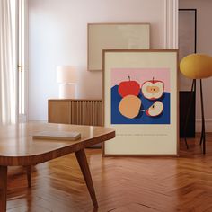 an art work is displayed in front of a coffee table and lamp on a wooden floor