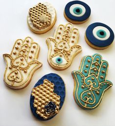 several decorated cookies with eyes and hamsa symbols