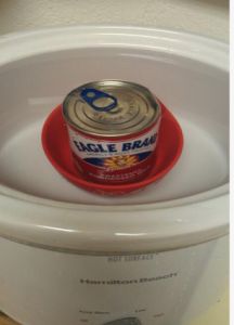 an open can of food sitting in the middle of a crock pot