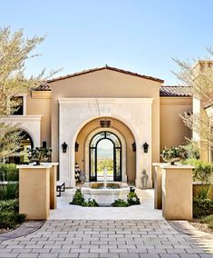 the entrance to a home with an arched doorway