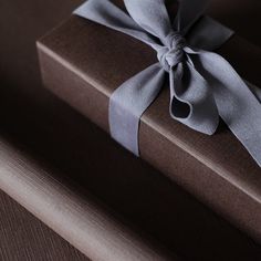 a brown box with a gray ribbon on it