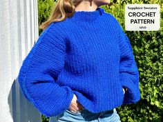 a woman wearing a blue sweater standing in front of a sign that says crochet pattern