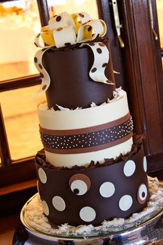 a three tiered cake is decorated with polka dots