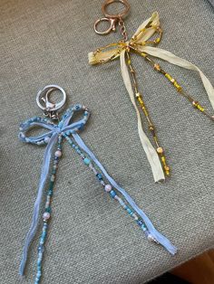 three different types of beads and key chains sitting on a table next to each other