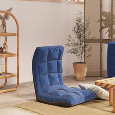 a living room with two blue chairs and a coffee table