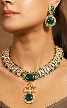 Description: A radiant choker necklace set featuring golden and green stones, made of brass with yellow plating. Draw string closure. Fine quality and craftsmanship. Perfect for desi weddings and cocktail dinners This  designer necklace is made with far size  stone in the centre & completed with pearls, multi colour agates & polkis.Ideal to be worn on festive, party & wedding occassions on your Indian & fusion attire.  Necklace comes in drawstring cord therefore adjustable Gold Plated Green Jewelry Sets For Festivals, Formal Temple Jewelry Kundan Choker Necklace, Green Gold Plated Bollywood Necklace, Formal Temple Jewelry Style Kundan Choker, Green Gold-plated Jewelry Sets For Festivals, Bollywood Style Green Gold-plated Necklace, Formal Temple Style Kundan Choker Necklace, Gold Bridal Necklace With Emerald Gemstone, Gold Emerald Bridal Necklace With Gemstones