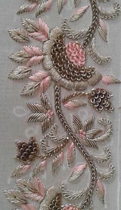 an embroidered piece with pink flowers and pine cones