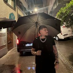 a woman walking down the street with an umbrella in her hand and a car parked on the side of the road behind her