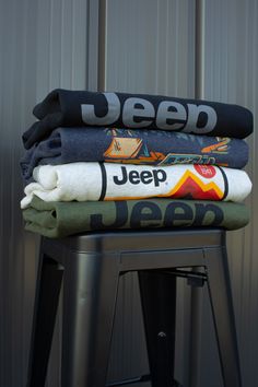 three folded towels sitting on top of a stool