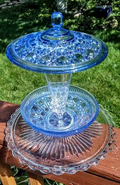 a blue glass cake plate sitting on top of a wooden table