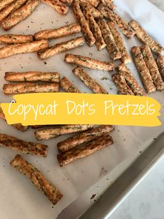 some food that is laying out on a tray with the words copycat dots pretzels