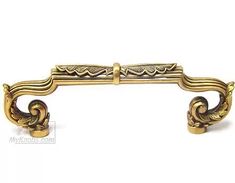 an ornate brass door handle on a white background