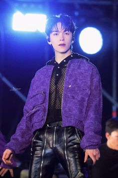 a male model in a purple jacket and leather pants