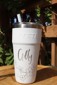 a white yeti cup sitting on top of a wooden table