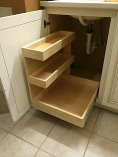 an open cabinet in the corner of a kitchen