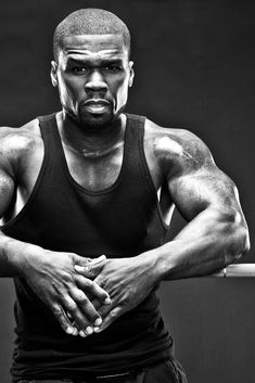 a black and white photo of a man with his arms crossed