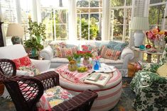 a living room filled with furniture and flowers