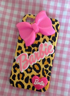 a cell phone case with a pink bow and name barbie on the front in leopard print