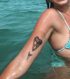 a woman with a tattoo on her arm in the water