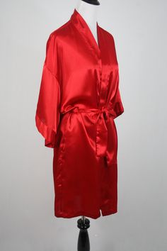 "1980s kimono style wrap robe. Polyester satin fabric. Short sleeves. Front patch pockets. Fastens with a sash belt. Label reads, \"Lingerie Cacique, 100% polyester made in Hong Kong, S.\" Freshly laundered. Excellent condition. Measurements: Shoulders = 23\" Bust = 46\" Waist = 46\" Hips = 46\" Sleeve = 10\" Length from top of shoulder to hem = 35\" All measurements are taken with the garment flat, doubled for the bust (chest), waist, hips, and circumference. Please make sure you leave yourself Sash Belts, Hawaiian Dress, Peasant Dress, Polyester Satin, Womens Robes, Skirt Suit, Kimono Fashion, Yellow Dress, Wrap Style