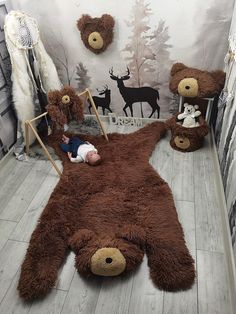 a baby laying on top of a teddy bear rug in a room with stuffed animals