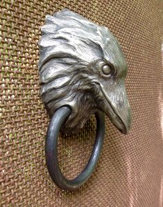 an eagle's head is attached to the handle of a doorknobl