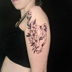 a woman with a tattoo on her arm has a horse head and flowers in it