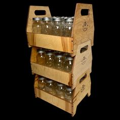 a wooden rack with mason jars on it's bottom shelf and two shelves below