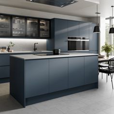 a modern kitchen with blue cabinets and white tile flooring is pictured in this image