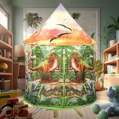 a child's play tent with dinosaurs on it in the middle of a room