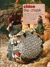 two turkey figurines sitting next to each other in hay with a sign above them