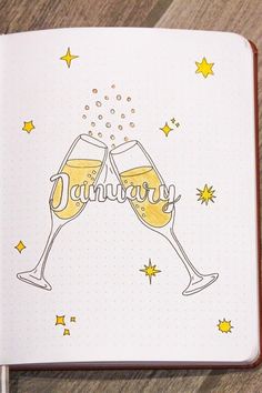 an open notebook with two glasses of champagne on the cover and stars in the background