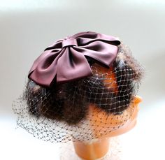 Vintage 1950s Womens Fur Hat with Brown Silk Bow and Birdcage Netting * 8 inches at longest side, about 4 inches high * Dark brown velvet with brown fur and chocolate brown ribbon bow. * No label (seems to have fallen off) * Birdcage netting is generally in good shape with a couple of holes that are not noticeable. Please inspect all photos carefully before purchase and feel free to convo us with any questions! See the rest of our vintage accessories here: https://www.etsy.com/shop/BosAndRubyVin Retro Brown Party Hat, Brown Party Fascinator Hat, Vintage Brown Wedding Hat, Christmas Hostess, Brown Ribbon, Hostess Apron, Silk Bow, Pillbox Hat, Brown Fur