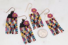 Add a pop of color to your outfit with these handcrafted beaded seed bead earrings! Measuring just over 2 inches long, these unique earrings feature bright colors perfect for adding a playful touch to any look. The floral accent adds a touch of whimsy, and the fringe detail adds a fun and trendy flair. Stand out from the crowd with these vibrant and stylish earrings that are sure to make a statement wherever you go.Lightweight and comfortable to wear. Each tiny bead is sewn into place one at a time with a needle and strong beading thread creating a piece of wearable art.✔️handmade in the USA✔️lightweight & comfortable ✔️golden brass ear wires (we also offer the option of gold filled or niobium ear wires if needed-just message us)✔️2 3/8 inches long ✔️3/4 inch wide✔️ships boxed and ready to Adjustable Multicolor Woven Beaded Earrings, Vibrant Colorful Beaded Drop Earrings, Unique Multicolor Beaded Chandelier Earrings, Vibrant Multicolor Beaded Earrings, Multicolor Hand-strung Beaded Earrings, Summer Salsa, Beading Thread, Stylish Earrings, The Fringe