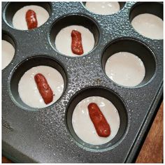 hotdogs in a muffin tin ready to be baked