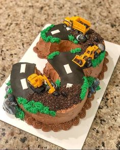 a birthday cake that is shaped to look like the number 50 with construction vehicles on it