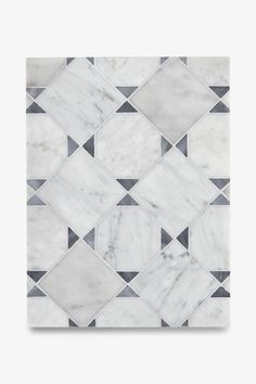 a white marble tile with black and grey squares