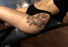 a woman's thigh with flowers on it