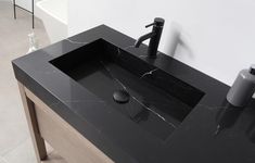 a bathroom sink sitting on top of a black counter