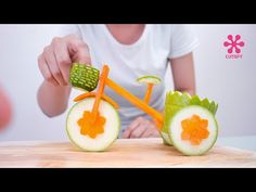 a woman cutting up vegetables with a bike shaped cutout in the shape of a flower