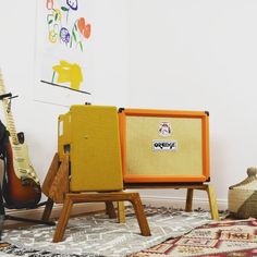 guitars and amps on display in an art gallery